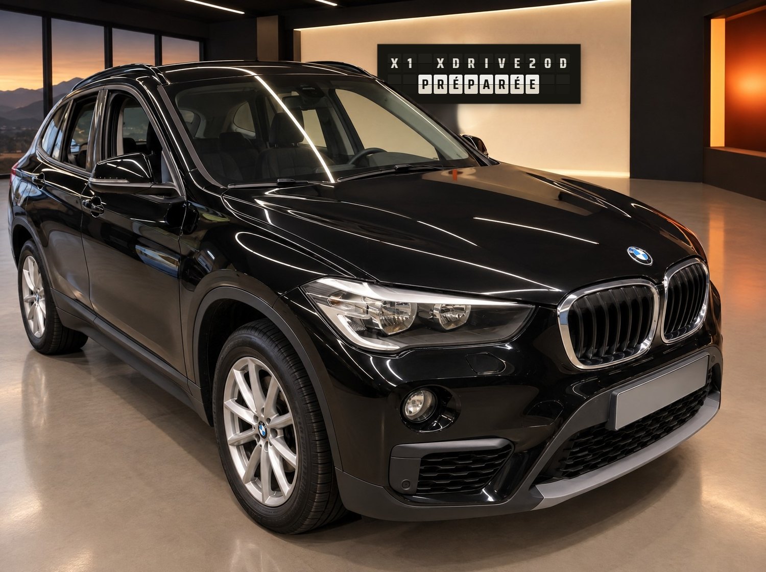 Le X1 préparé ; au mur, le tableau affiche X1 XDRIVE20D PRÉPARÉE